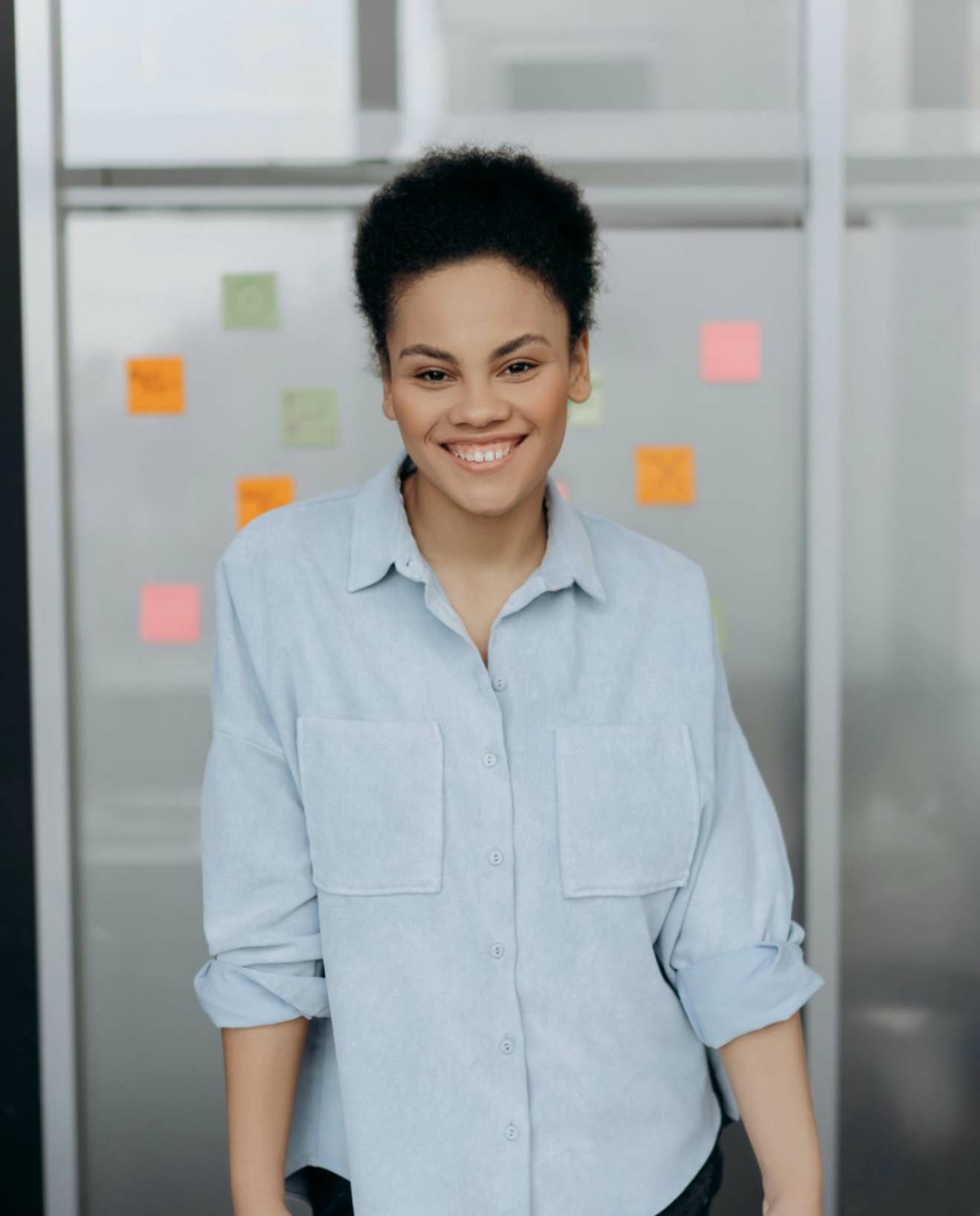 Smiling woman in a casual shirt giving a customer review.